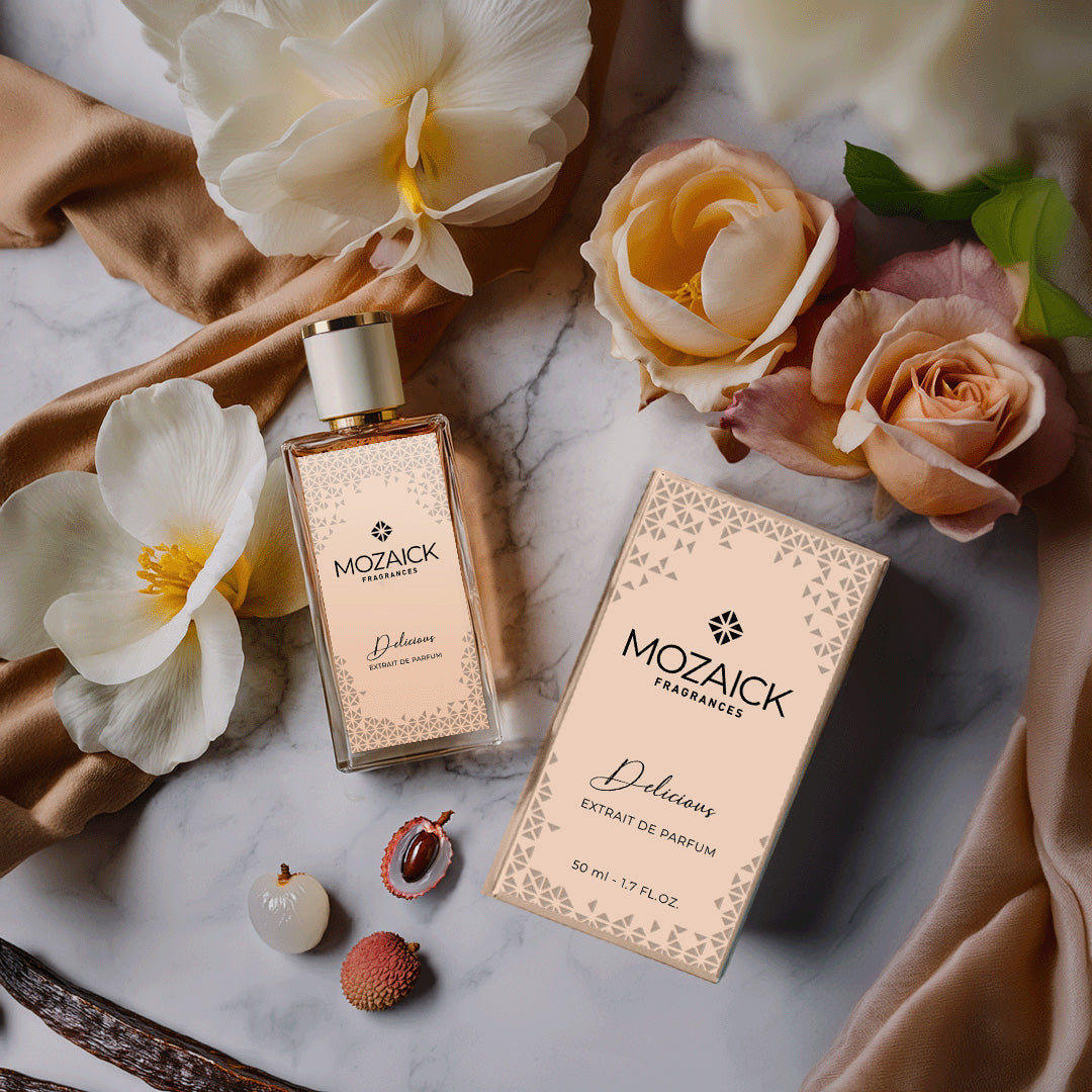 DELICIOUS Extrait de Parfum 50 ml by MOZAICK – bottle and box on marble with pale flowers and lychees